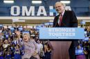 Democratic presidential candidate Hillary Clinton, left, waves to members of the audience as she and Berkshire Hathaway Chairman and CEO Warren Buffett, right, arrive at a rally at Omaha North High Magnet School in Omaha, Neb., Monday, Aug. 1, 2016. (AP Photo/Andrew Harnik)