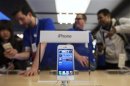 An Apple iPhone 5 phone is displayed in the Apple Store on 5th Avenue in New York