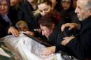 Asiye, mother of Destina Peri Parlak, one of the victims of Sunday's suicide bomb attack, mourns over her daughter's coffin during a funeral ceremony in Ankara