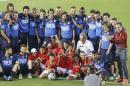 The Italian national soccer team poses for a photo with visiting children, prior a training session in Natal, Brazil, Saturday, June 21, 2014. Italy proved ineffective in a 1-0 loss to Costa Rica on Friday and now the Azzurri need a win or a draw against Uruguay on Tuesday to reach the second round. (AP Photo/Antonio Calanni)