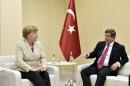 Turkish Prime Minister Davutoglu meets with German Chancellor Merkel upon her arrival at Gaziantep airport