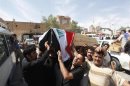 Residents carry the coffin of a victim, who was killed in a bomb attack, during a funeral in Najaf