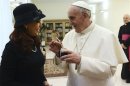Newly elected Pope Francis holds a mate given to him from Argentine President Cristina Kirchner at the Vatican
