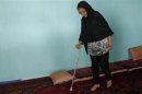 Muzhgan Masoomi, 22, walks in her house in Kabul