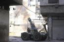 Rebel fighters fire an artillery cannon towards forces loyal to Syria's President Bashar al-Assad in eastern al-Ghouta