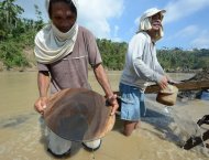 Miners pan for gold at a river near the typhoon disaster zone in Mawab town, Compostela Valley province, on December 9. The worst-hit southern town of New Bataan is host to some of the thousands of illegal gold-mining operations in Compostela Valley