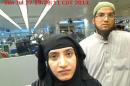 Tashfeen Malik and Syed Farook are pictured passing through Chicago's O'Hare International Airport in this July 27, 2014 handout photo