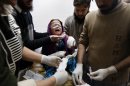 A Pakistani baby girl injured in a rocked attack by militants, is treated at a local hospital in Peshawar, Pakistan on Saturday, Dec. 15, 2012. Militants fired three rockets at an airport in the northwestern Pakistani city of Peshawar on Saturday night, killing several people and wounding dozens, officials said. (AP Photo/Mohammad Sajjad)