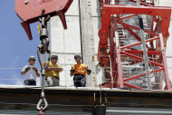 <p>               In this Monday, July 9, 2012 workers talk at a construction site in Boston. U.S. construction spending fell in July from June by the largest amount in a year, weighed down by a big drop in spending on home improvement projects.(AP Photo/Elise Amendola)
