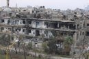 Damaged buildings are seen in al-Bayada district in Homs