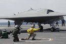 FILE - A Navy X-47B drone is launched off the nuclear powered aircraft carrier USS George H. W. Bush off the coast of Virginia, in this May 14, 2013 file photo. The Navy says the X-47B experimental aircraft will try to land aboard the USS George H.W. Bush on Wednesday July 10, 2013. (AP Photo/Steve Helber, File)