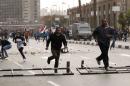 Anti-government protesters run as police arrive during their attempt to walk into Tahrir square in Cairo