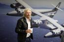 FILE - This Sept. 25, 2013 file photo shows British entrepreneur Richard Branson at the Virgin Galactic hangar at Mojave Air and Space Port in Mojave, Calif. NBC says it will air a competition show with an out-of-this-world prize: a ride into space. The network said Thursday, Oct. 3, that TV producer Mark Burnett is teaming with Richard Branson's Virgin Galactic on "Space Race," a game where the winner will get a ride on Virgin's aircraft atop the Earth's atmosphere. (AP Photo/Reed Saxon, File)