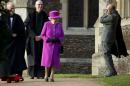 Britain's Queen Elizabeth II and her husband Prince Philip, right, leave after attending the British royal family's traditional Christmas Day church service at St. Mary Magdalene Church in Sandringham, England, Thursday, Dec. 25, 2014. (AP Photo/Matt Dunham)