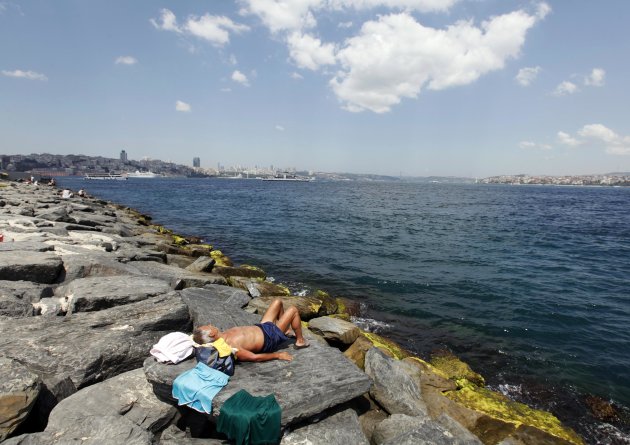 A man sunbathes near the seaside …