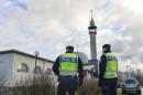 Two policemen stand outside a mosque in Uppsala, Sweden, Friday, Jan. 2, 2015 as police tighten security around some of Sweden's main mosques. The mosque suffered a firebomb attack on Jan. 1, one of three arson attacks targeting the Muslim community in Sweden since Christmas Day. (AP Photo/Anders Wiklund) SWEDEN OUT