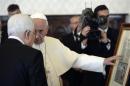 Pope Francis exchanges gifts with Palestinian President Mahmoud Abbas during a private audience in the pontiff library at the Vatican