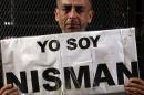 Marcelo Novillo, whose son Adrian was a victim of a violent crime, cries as he holds up a sign that reads "I am Nisman" in Buenos Aires
