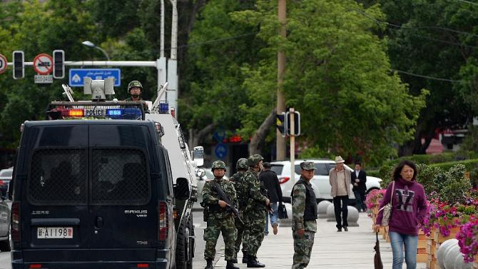 Chinese paramilitary police stand guard in Urumqi -- the capital of the Muslim Uighur region of Xinjiang -- on May 23, 2014