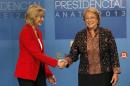 Chilean presidential candidates Michelle Bachelet and Evelyn Matthei shake hands during a live televised debate in Santiago