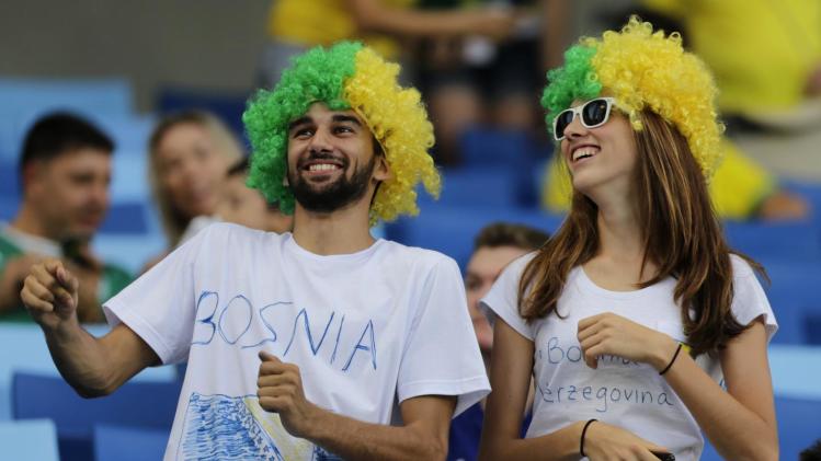 Bosnia soccer team supporters dance in the stadium before the group F World Cup soccer match between Nigeria and Bosnia at the Arena Pantanal in Cuiaba, Brazil, Saturday, June 21, 2014