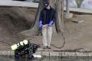 A FBI diver searches the water at Seccombe Lake Park after the shooting earlier this month in San Bernardino, California