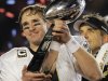 FILE - In this Feb. 7, 2010, file photo, New Orleans Saints quarterback Drew Brees celebrates with the Vince Lombardi Trophy after the Saints' 31-17 win over the Indianapolis Colts in the NFL Super Bowl XLIV football game in Miami. Brees has agreed to a five-year, $100 million contract with the Saints, with $60 million guaranteed, on Friday, July 13, 2012, a person familiar with the deal tells The Associated Press. (AP Photo/Julie Jacobson, File)
