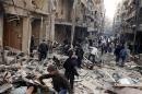 Residents look for survivors through damage by what activists said was an airstrike with explosive barrels from forces loyal to President Bashar al-Assad in Al-Shaar area in Aleppo