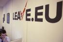 A worker answers a telephone in the office of Brexit group pressure group "Leave.eu" in London, Britain