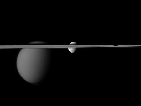 The Cassini spacecraft's view of the moons Tethys and Titan are disrupted by the rings of Saturn in this December 7, 2011 NASA handout obtained by Reuters January 13, 2012. REUTERS/NASA/JPL-Caltech/Space Science Institute/Handout/Files