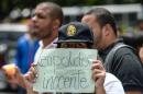 A supporter of jailed opposition leader Leopoldo Lopez holds paper reading "Leopoldo Innocent" in Caracas on September 11, 2015