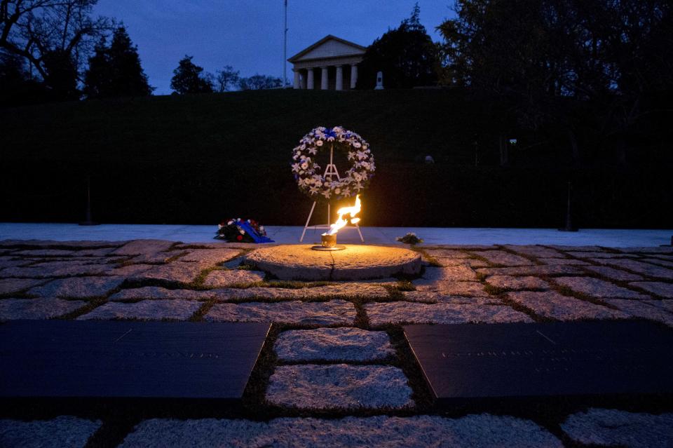 The eternal flame shines in the early morning light at the grave of John F. Kennedy at Arlington National Cemetery on Friday, Nov. 22, 2013, on the 50th anniversary of Kennedy's death. (AP Photo/Jacquelyn Martin)
