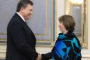 Ukraine's President Viktor Yanukovych, left, greets EU foreign policy chief Catherine Ashton prior their talks in Kiev, Ukraine, Wednesday, Dec. 11, 2013. At least, European Union leaders can count on support from the tens of thousands of demonstrators who throng the center of Kiev on a regular basis as a tool to pressure Yanukovych to change his mind. (AP Photo/ Mykhailo Markiv, Pool)