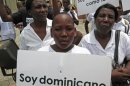 FILE - In this Aug. 12, 2013 file photo, a youth of Haitian descent holds a sign that reads in Spanish "I'm Dominican" during a protest demanding that President Danilo Medina stop the process to invalidate their birth certificates after authorities retained their ID cards, in Santo Domingo, Dominican Republic. The Dominican Republic's top court on Thursday, Sept. 26, 2013 stripped citizenship from thousands of people born to migrants who came illegally, a category that overwhelmingly includes Haitians brought in to work on farms. The decision cannot be appealed, and it affects all those born since 1929. (AP Photo/Ezequiel Abiu Lopez, File)