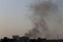 Black smoke raises into the air near Benghazi port, where there are violent clashes, in Benghazi