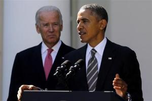 Biden stands with Obama as he announces Johnson to be his nominee for Secretary
 of Homeland Security, in the Rose Garden of the White House in Washington