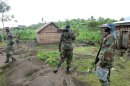 Fighters of the M23 rebel group take positions in Mutaho on June 3, 2013 about 15 kms from Goma
