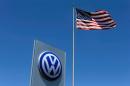 FILE PHOTO: A U.S. flag flutters in the wind above a Volkswagen dealership in Carlsbad