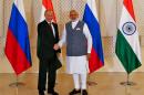 Russian President Vladimir Putin shakes hand with India's Prime Minister Narendra Modi during a photo opportunity ahead of India-Russia Annual Summit in Benaulim, in the western state of Goa