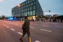 A policeman patrols as people are beeing evacuated from the Olympia Einkaufzentrum (OEZ) in Munich