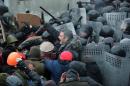 Head of UDAR (Punch) party and one of the leaders of the opposition Vitali Klitschko (C) tries to stop clashes between police and protesters on January 19, 2014 during an opposition rally in the centre of the Ukrainian capital Kiev