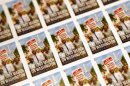 A sheet of the U.S. Postal Service stamp commemorating the 50th anniversary of the March on Washington is seen during an unveiling event at the Newseum in Washington, Friday, Aug. 23, 2013. (AP Photo/Charles Dharapak)