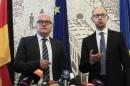 German Foreign Minister Frank-Walter Steinmeier, left, and Ukrainian Prime Minister Arseniy Yatsenyuk take part in a briefing in Kiev, Ukraine, Tuesday, May 13, 2014. Steinmeier flew to Ukraine Tuesday to help start talks between the Ukrainian government and its foes following the declaration of independence by two eastern regions. (AP Photo/Sergei Chuzavkov)