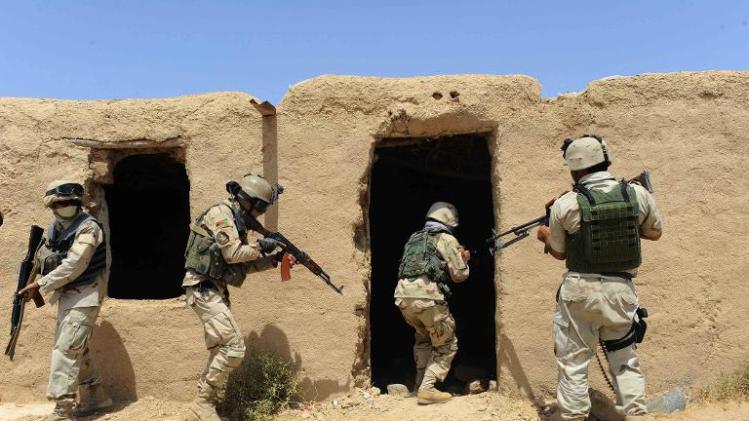 Afghan security forces search a building following an insurgent attack on a road construction workers' camp in Karukh district of Herat on August 17, 2013