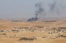 Smoke rises from villages in southern rural area of Manbij, in Aleppo Governorate