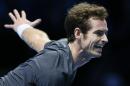 Britain's Andy Murray serves to Switzerland's Roger Federer during their singles ATP World Tour Finals tennis match at the O2 Arena in London, Thursday, Nov. 13, 2014. (AP Photo/Kirsty Wigglesworth)