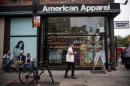 People walk past an American Apparel store on June 19, 2014 in New York City
