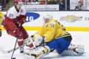 Sweden goalie Linus Soderstrom (30) stops Denmark forward Oliver Bjorkstrand (27) during the third period of a preliminary round game at the World junior ice hockey championships in Toronto, Saturday, Dec. 27, 2014. (AP Photo/The Canadian Press, Nathan Denette)