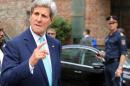 U.S. Secretary of State John Kerry gestures as he arrives in front of a hotel where closed-door nuclear talks on Iran take place in Vienna, Austria, Sunday, July 13, 2014. Kerry and fellow foreign ministers are adding their diplomatic muscle to nuclear talks with Iran, with a target date only a week away for a pact meant to curb programs Tehran could turn to making atomic arms. (AP Photo/Ronald Zak)
