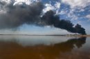 A column of smoke rises, a day after an explosion at Amuay oil refinery in Punto Fijo in the Peninsula of Paraguana